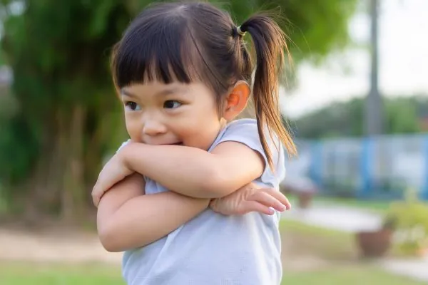 Portrait image of 2-3 years old of toddler baby girl. Happy Asian child feeling shy. She playing with the toy at the park playground. Learning and kid concept.